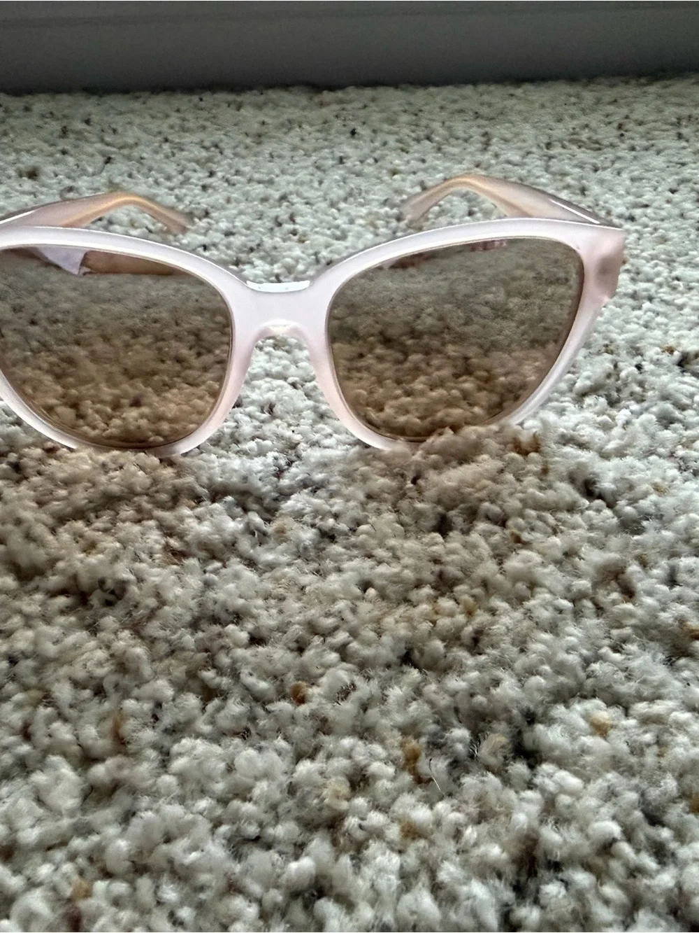 Tory Burch Pale Pink Frame Sunglasses with cat eye shape with gold detail.